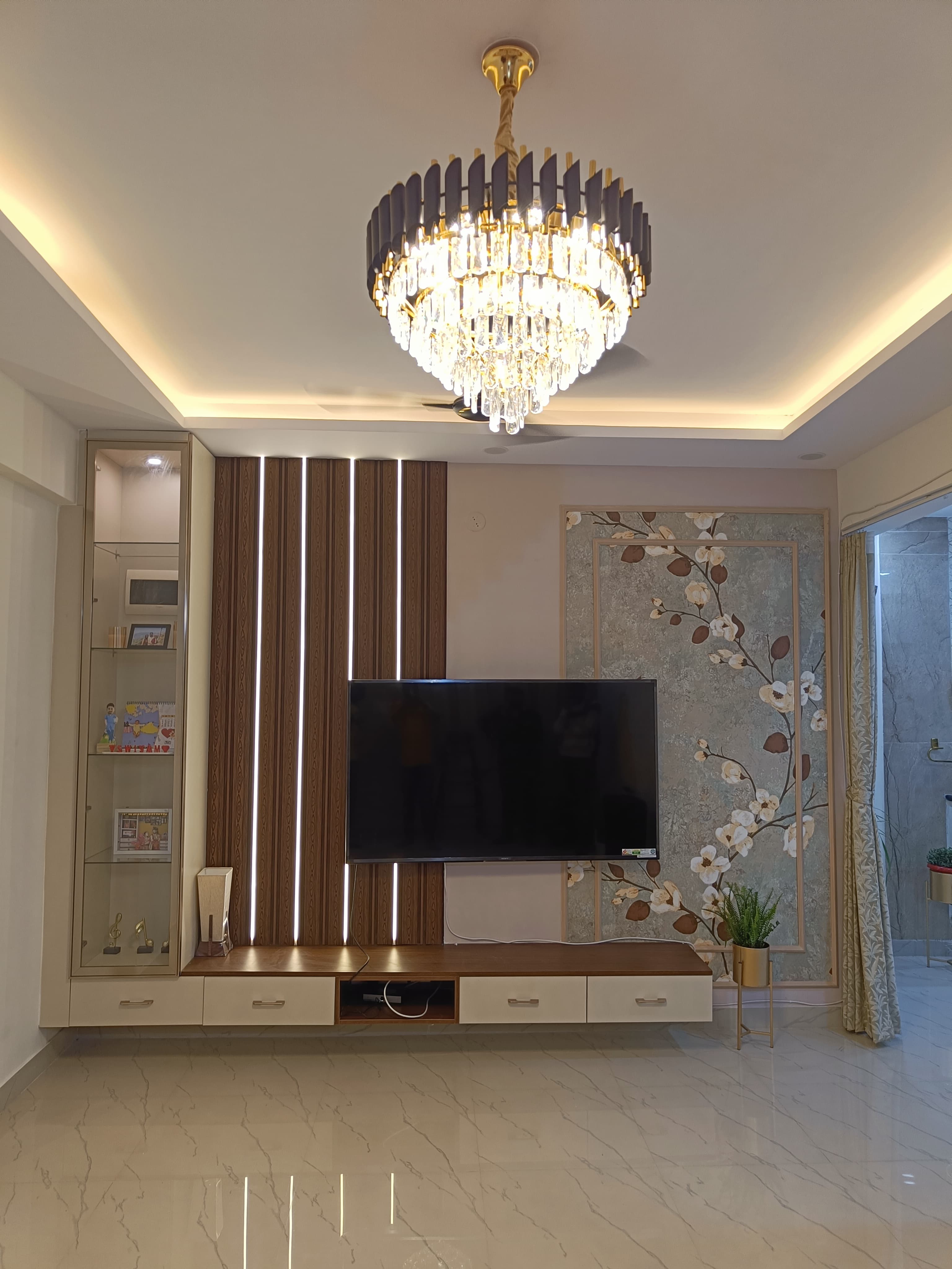 Restored heritage home interior with preserved carved wooden pillars, updated lighting, and modern amenities